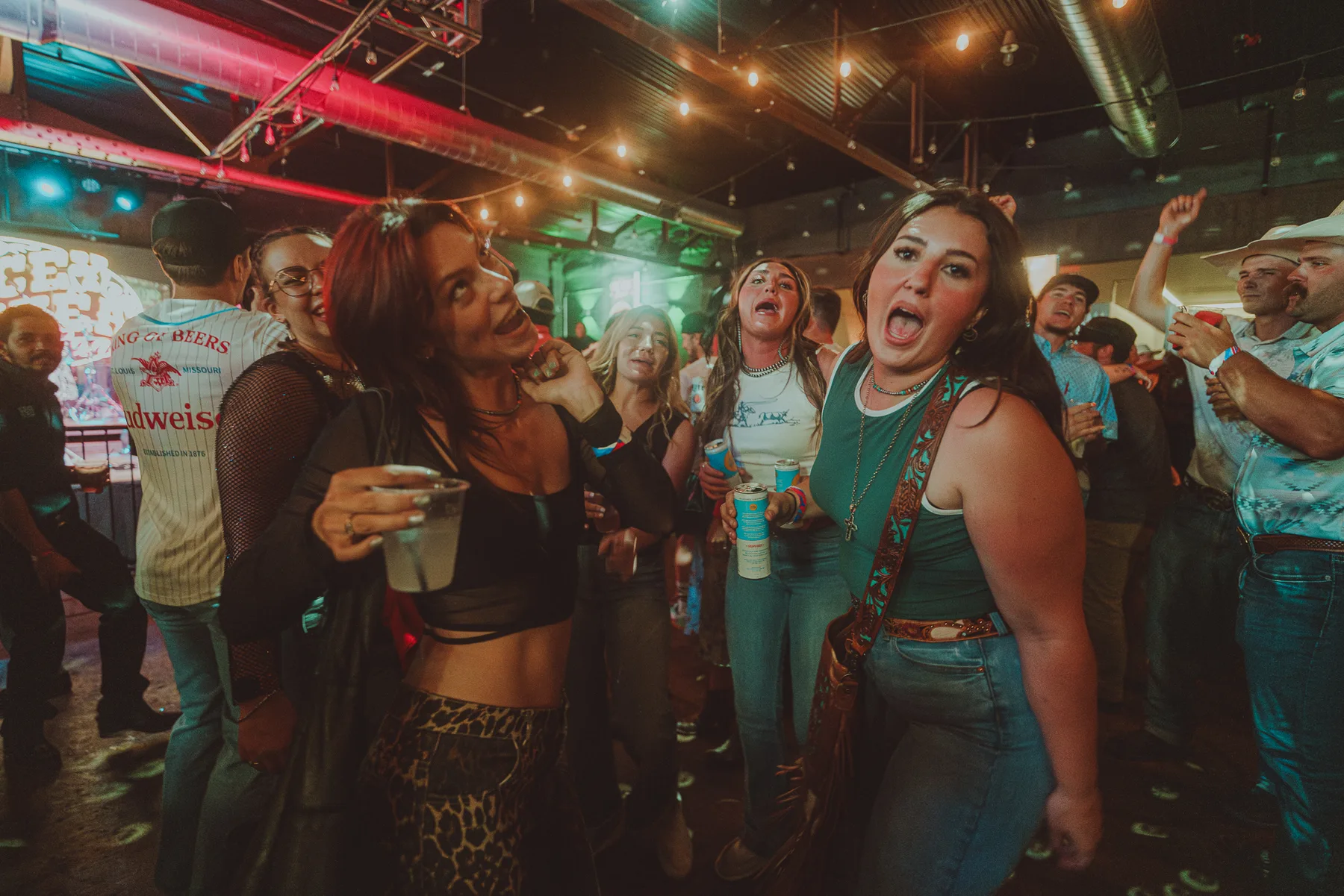 Friends celebrating together in the Gaslight Social crowd